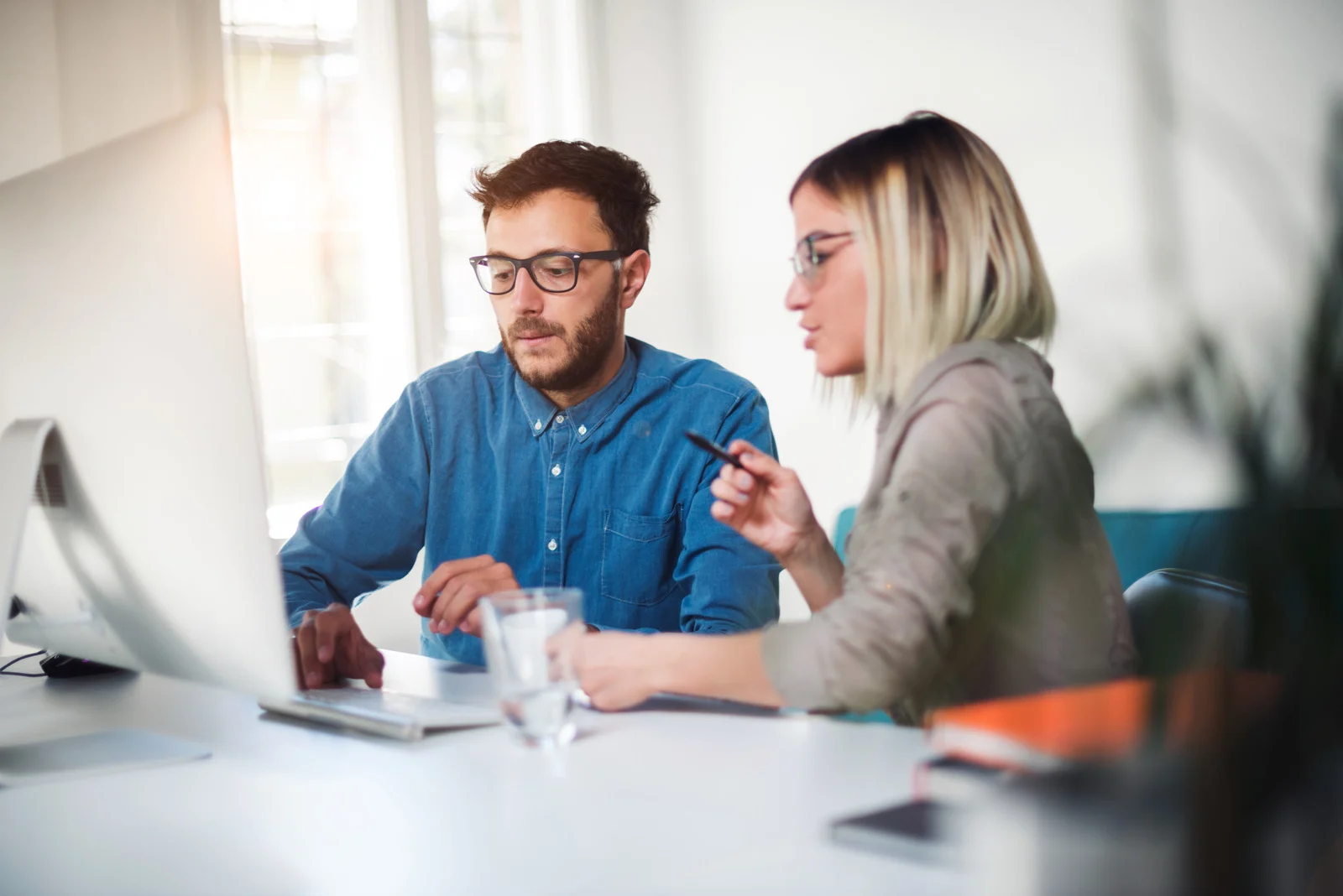 A friendly business meeting between a small business owner and an SEO consultant discussing strategies