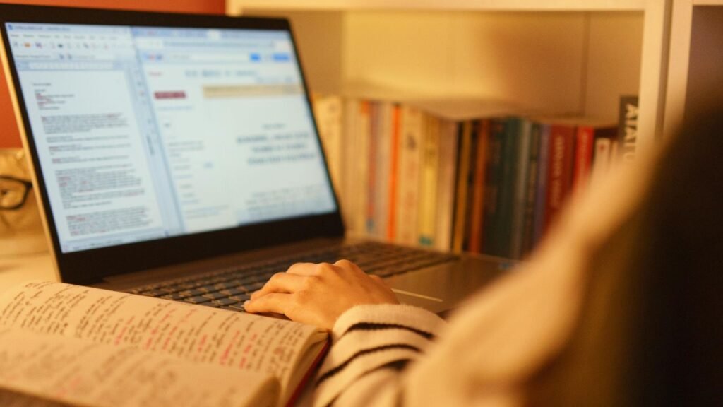 A graphic showing a person studying SEO trends with books and a laptop surrounded by search engine icons