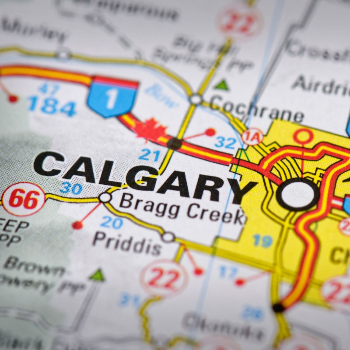 Calgary skyline at sunset. Floating in the foreground is a transparent digital "Heatmap" of the city. 